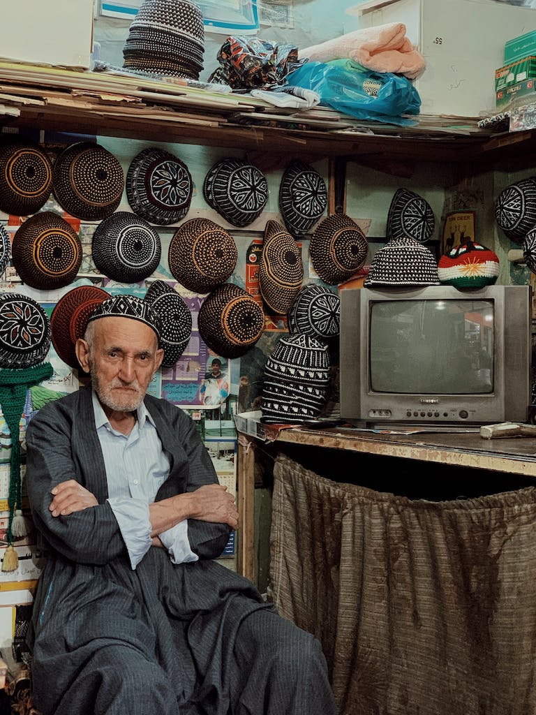 Local senior man selling traditional caps